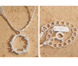 Detailed close-up of S925 silver necklace featuring moonstone, butterfly and flower charms