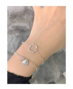 Close-up of S925 silver layered bracelet with heart charm and moonstone thorn ring