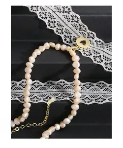 Detail of S925 silver clasp and baroque pearls with heart pendant on black lace