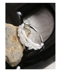 Macro view of S925 sterling silver ring showing layered smooth and hammered textures