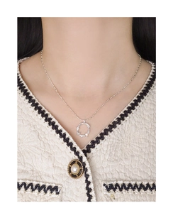 Detailed view of S925 silver necklace with wreath pendant and moonstone on a model
