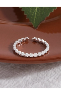 Close-up of S925 sterling silver ring with delicate floral petal band design