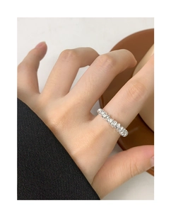 Macro shot of a minimalist irregular spiral S925 sterling silver ring worn on a hand