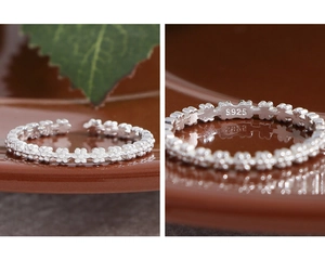 Detailed macro view of S925 sterling silver ring showing embossed flower patterns