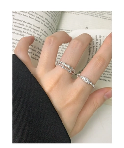 Close-up of minimalist S925 silver double-layer rings and textured band on finger