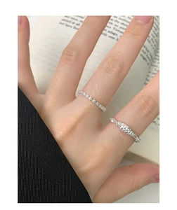 Detail of stacked S925 sterling silver rings with beaded and textured woven design