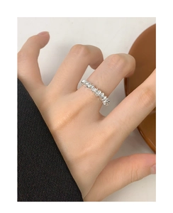 Close-up of S925 sterling silver irregular spiral ring worn on female index finger