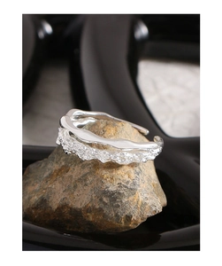 Macro detail of irregular silver S925 ring showing lava texture on natural stone