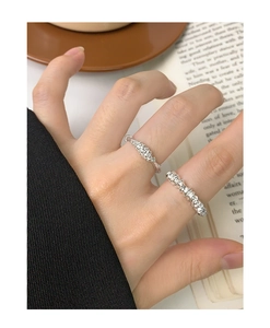 Detail of S925 sterling silver stacked rings with twisted rope and shimmering textures