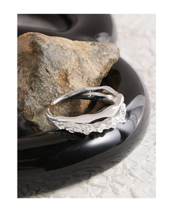 Detailed close-up of S925 silver irregular lava texture on an open double-layer ring