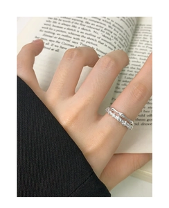 Macro shot of double-layered S925 silver ring featuring wavy band and zircon inlay detail