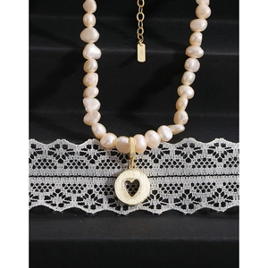 Baroque pearl necklace with S925 silver hollow heart pendant on black background