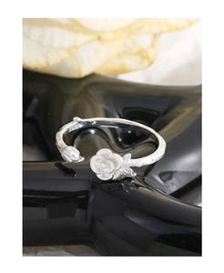 Detail shot of the vintage S925 sterling silver rose bud flower open ring on a stand