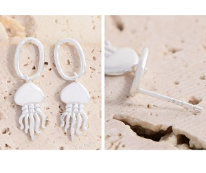 Gros plan des boucles d'oreilles méduse en argent S925 montrant le poinçon et les détails