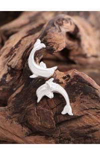 Close-up of S925 sterling silver dolphin stud earrings showing the hallmark on metal
