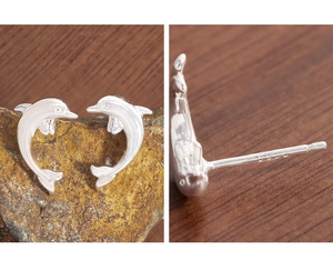 Macro detail of S925 sterling silver stamp on minimalist dolphin stud earrings