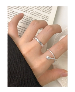 Detail of minimalist S925 sterling silver rings on hand with high polish finish