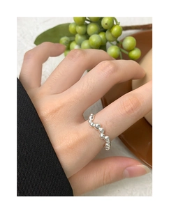 Macro shot of S925 sterling silver beaded wave ring showing smooth metallic luster