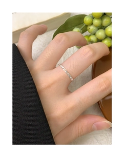 Close-up of minimalist S925 sterling silver ring featuring a hollow heart pattern design