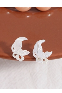 Macro shot of S925 sterling silver moon stud earrings with delicate hollow patterns