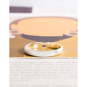 Minimalist S925 sterling silver open ring with polished finish on a magazine background