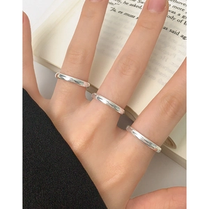 Three-piece set of minimalist S925 sterling silver polished round bands worn by a model