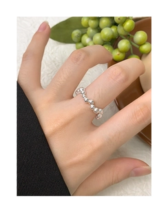Close-up of minimalist S925 sterling silver beaded ring on finger with polished finish