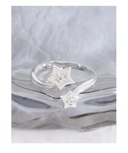 Close-up of S925 sterling silver star ring featuring zircon stones and engraved hallmark
