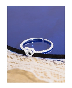 Close-up of S925 sterling silver ring featuring a hollow heart and beaded band texture