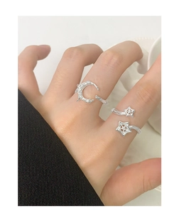Close-up of S925 silver moon and star open rings set on model hand with a polished finish