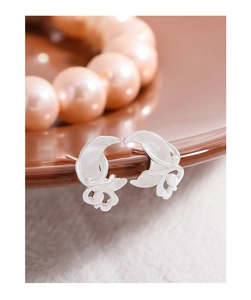 Detail shot of S925 silver crescent moon and butterfly studs with white mother of pearl