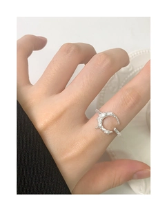 Close-up of S925 silver crescent moon ring with texture and sparkling zircon stones