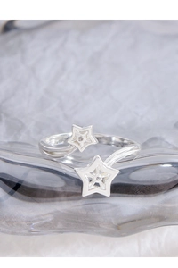 Detail of silver S925 double star open ring with sparkling cubic zirconia inlay