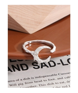 Macro detail of S925 sterling silver moon ring with irregular hammered texture and open band