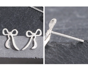Macro view of S925 sterling silver hallmark on elegant ribbon bow stud earrings