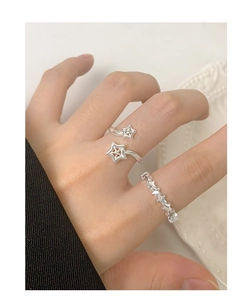 Close-up of S925 sterling silver star rings with zircon stones on a female hand