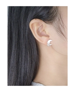 Close-up of S925 sterling silver moon petal stud earring worn by a female model