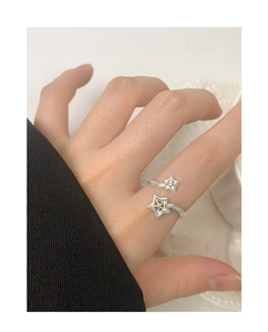 Detail of adjustable S925 sterling silver ring with star zircon design on a hand