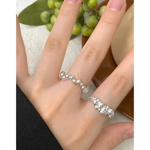 S925 sterling silver beaded ring and heart pattern band shown on a model's hand