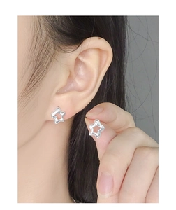 Detail of S925 silver irregular hollow star earrings with a liquid metal texture finish