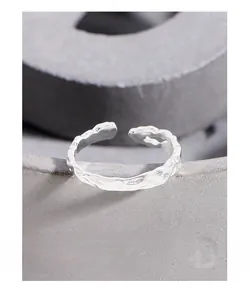 Macro close-up of S925 silver ring featuring a unique molten lava texture and open design