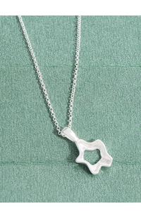 Detailed macro view of S925 hallmark on minimalist irregular hollow star necklace