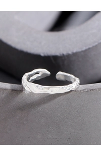 Macro shot of S925 sterling silver ring featuring unique irregular lava texture finish