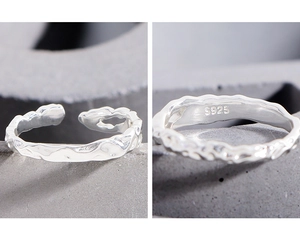 Macro shot of S925 sterling silver stamp on minimalist lava texture open ring band