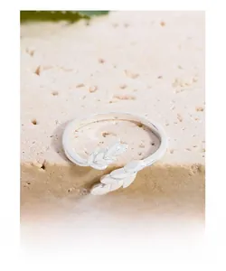 Close-up of S925 sterling silver ring with wheat leaf design on a textured stone surface