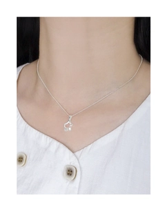 Detail showing irregular hollow star pendant necklace on model with white textured shirt