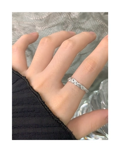 Detail of S925 silver ring featuring unique molten liquid texture on female index finger