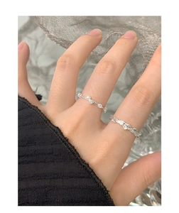Detail of S925 silver lava texture ring and zircon set worn on a model finger
