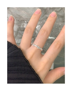 Detail view of S925 sterling silver ring with irregular lava texture worn on the finger