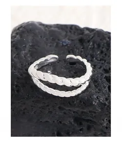 Detailed macro shot of the S925 sterling silver stamp on the double-layer twisted ring
